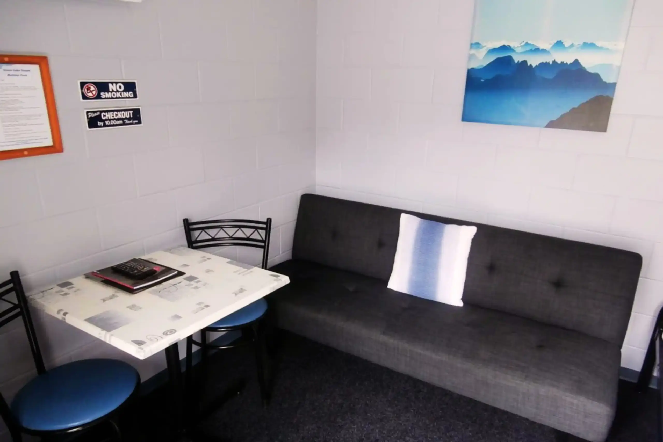 Great Lake Holiday Park Campground Cabin Room Only Inside Seating Simple standard cabin with heating, cooling and TV at Great Lake Holiday Park Taupo.